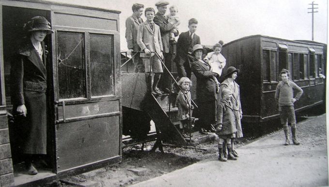 Passengers crossing rail on steps bogey